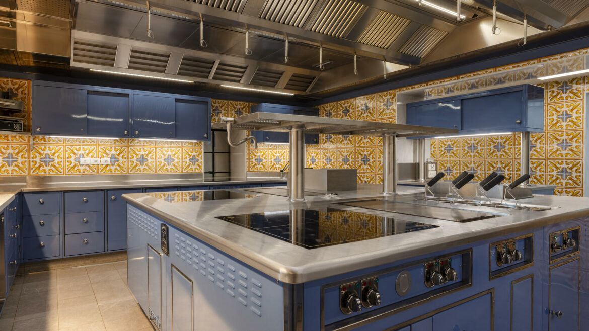 Elegant Molteni kitchen in blue with yellow and blue tiles on the walls