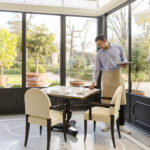 Dining room in Onde sunroom with a waiter setting up the table